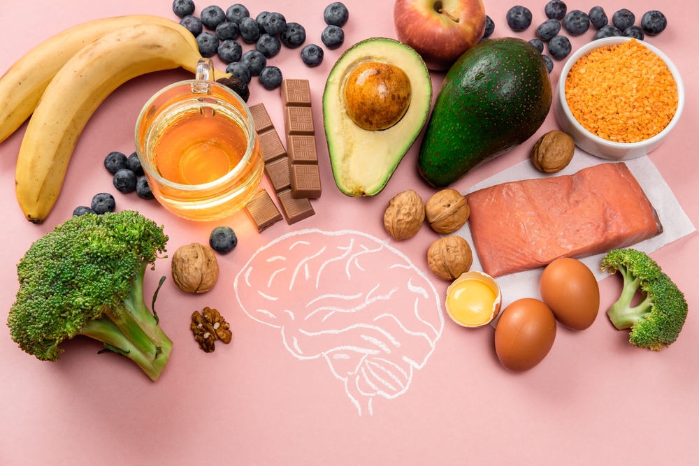 Foods that support brain and mood health—like salmon, avocado, eggs, and berries—illustrating how nutrition and genes interact. Perfect for promoting SuperDNA’s nutrigenomics DNA test for mental health and emotional wellness.